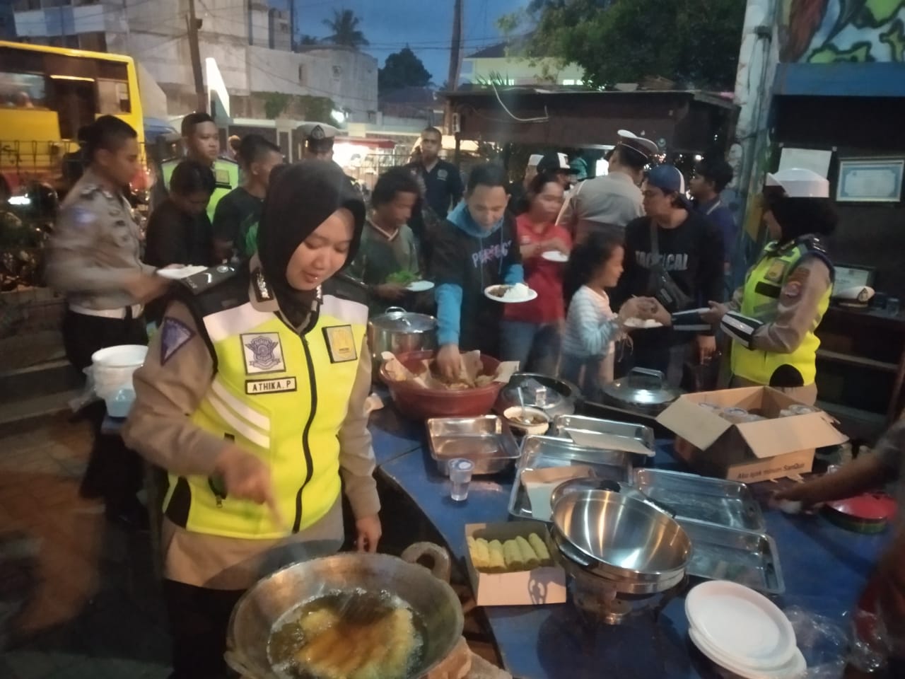 Tampak Petugas Satlantas Polresta Tangerang saat memberhentikan pengendara roda dua untuk mengajak berbuka puasa bersama dengan para pengendara lainnya.