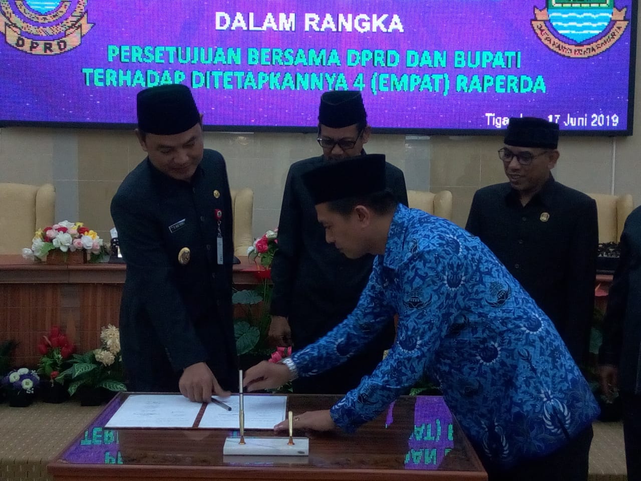 Ketua DPRD Kabupaten Tangerang, Sumardi saat menyerahkan dokumen Raperda kepada Wakil Bupati Tangerang, Mad Romli dalam Rapat Paripurna di Gedung DPRD Kabupaten Tangerang, Senin (17/6/2019).