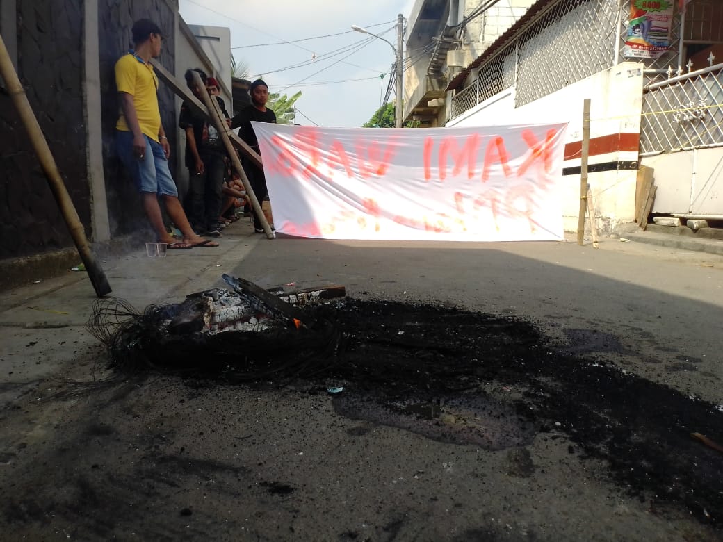 Tampak warga membakar ban di akses jalan masuk sekolah SMPN 13 Tangerang Selatan di Jalan Beruang, II RT 01 RW 02, Pondok Ranji, Ciputat Timur, Senin (22/7/2019).