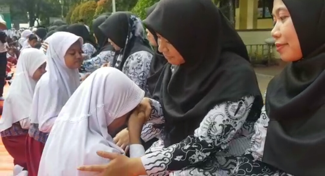 Suasana para murid sungkeman kepada gurunya dalam Kegiatan peringatan Hari Guru Nasional di Sekolah Dasar Negeri Pondok Kacang Barat 03, Kota Tangerang Selatan.