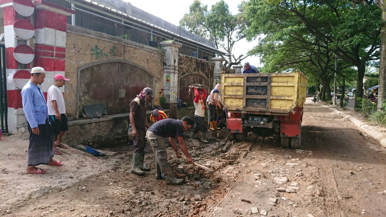 Sejumlah pekerja mengeruk lumpur dalam upaya perbaikan jalan rusak di Jalan Boulevard 1 Perumahan Taman Royal, Kota Tangerang, Senin (9/3/2020).