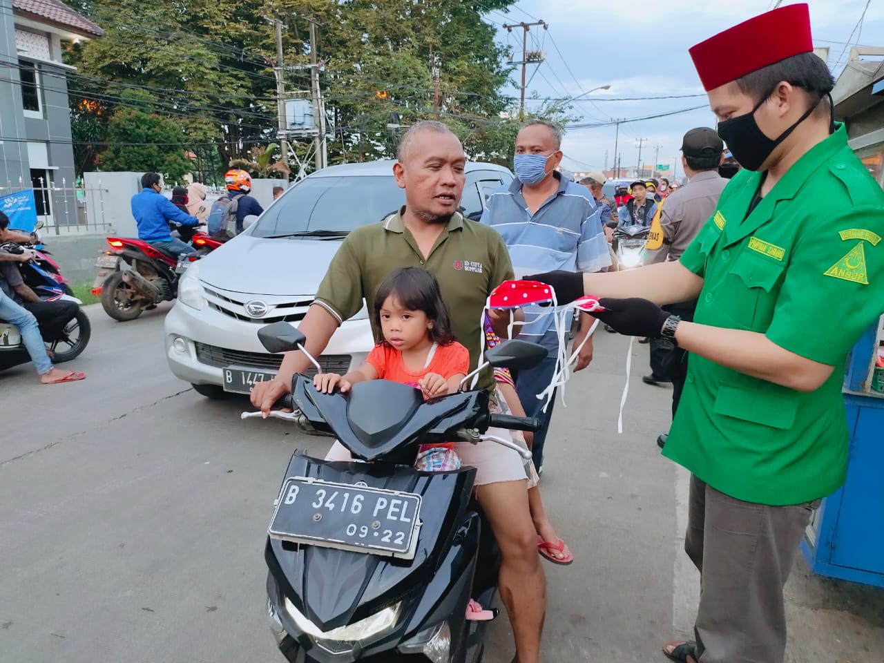 Aksi sosial Gerakan Pemuda Ansor Curug membagikan masker kepada pengendara yang melintas di Jalan PLP Curug, Minggu (3/5/2020)