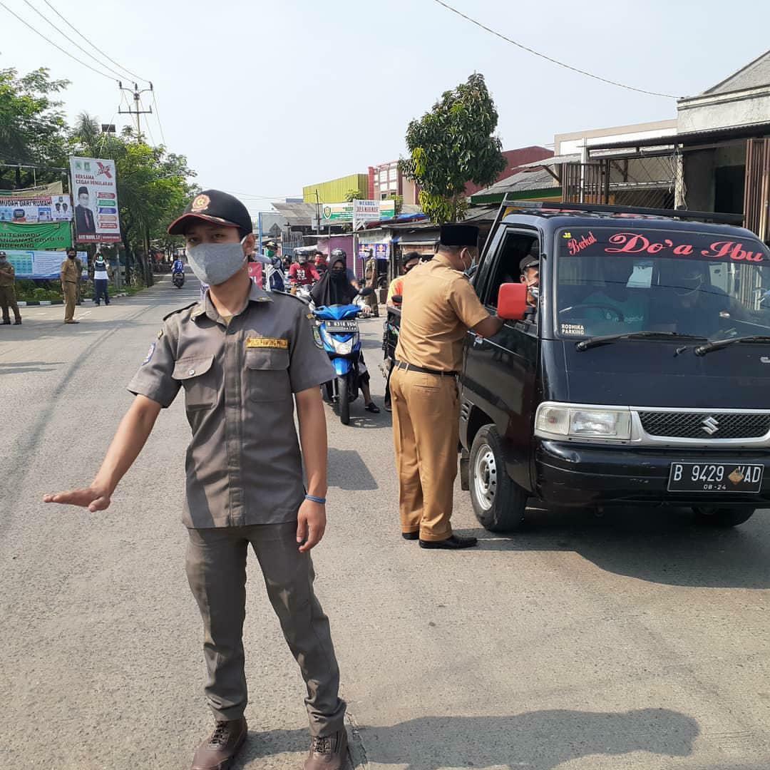 Petugas menggelar operasi PSBB di Kecamatan Pinang, Kota Tangerang, Minggu.(12/7/2020).