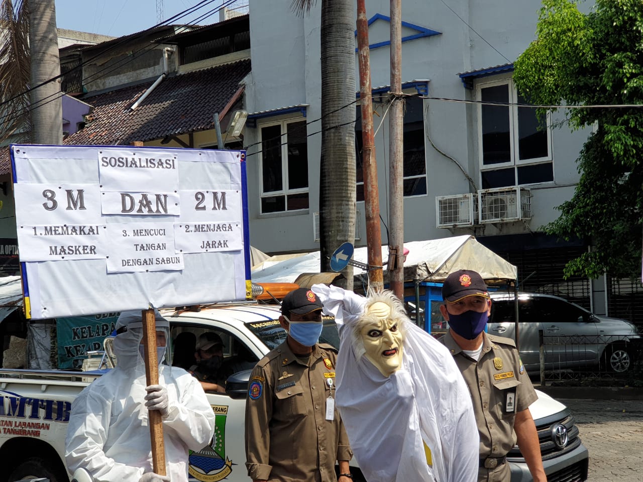 Petugas yang mengenakan pakaian menyerupai pocong diterjunkan untuk mendisiplinkan masyarakat Kota Tangerang di kawasan Pasar Kreo dan Cipadu, Kecamatan Larangan, Kota Tangerang, Rabu (16/9/2020).