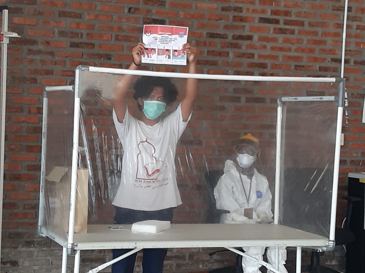 Seorang pasien terinfeksi COVID-19 tetap menunjukkan antusiasnya saat mengikuti kontestasi Pilkada di Rumah Lawan COVID-19 (RLC) Tangerang Selatan, Rabu (9/12/2020).