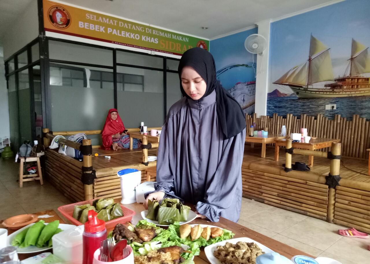 Owner Nurul Humaera Irwan menggunting pita secara simbolis sebagai persemian rumah makan Bebek Palekko khas Sidrap, Makassar di kawasan KH Hasyim Ashari, Kecamatan Ciledug, Kota Tangerang.