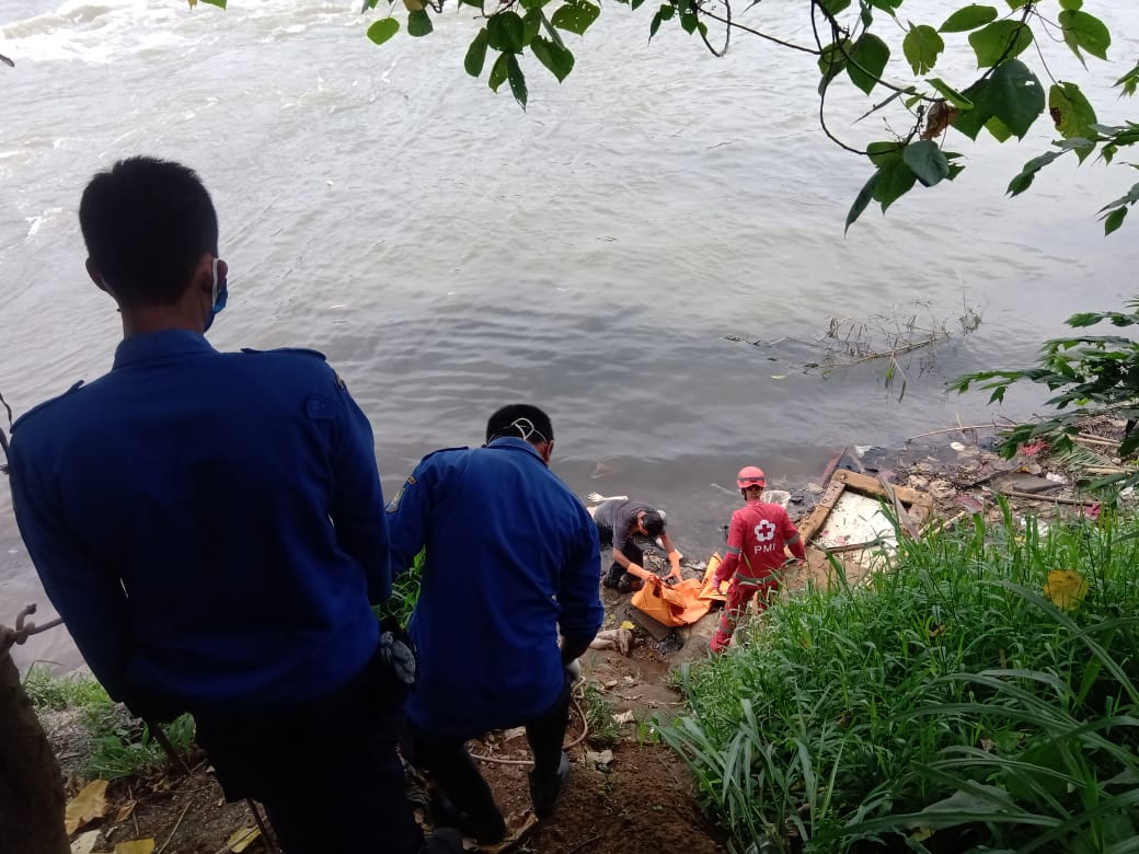 Petugas gabungan saat mengevakuasi mayat pria yang mengambang setelah tenggelam di Sungai Cisadane Tangerang, Jumat (30/10/2020).