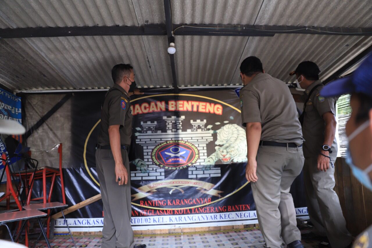 	Petugas Satpol PP saat melepaskan atribut ormas di Taman Elektrik, Puspemkot Tangerang.